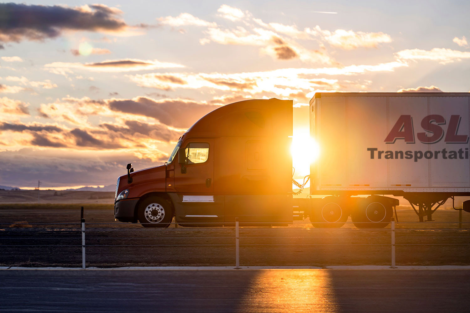 ASL sleeper truck with sun flare behind.